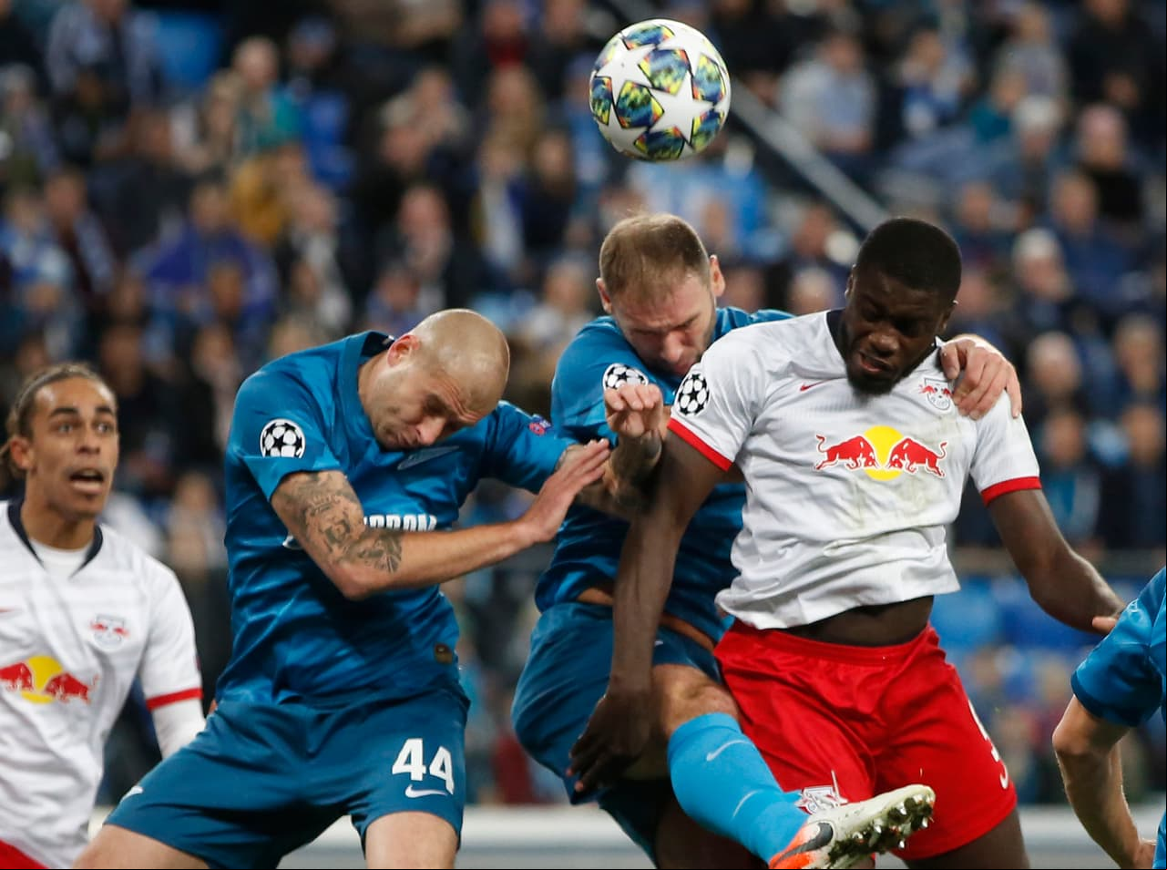 Yaroslav Rakitskiy y Branislav Ivanovic del Zenit, pelean por el baón con Dayot Upamecano del Zenit.