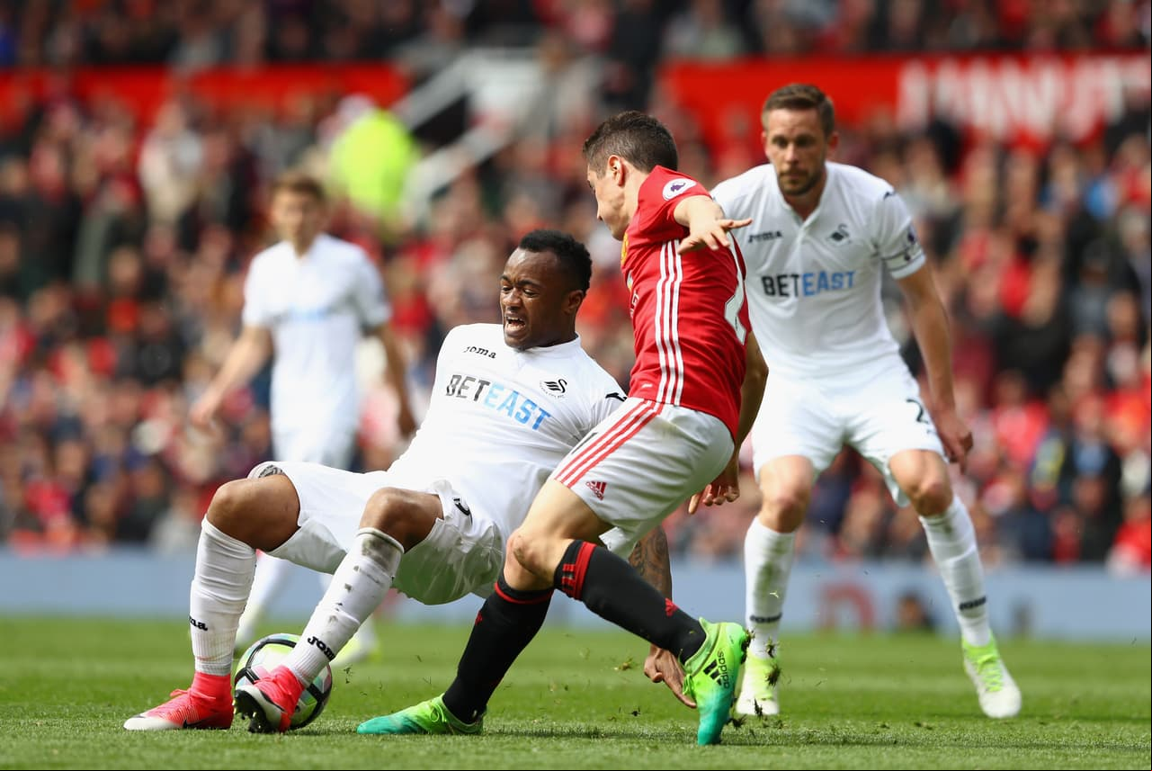 MANCHESTER, ENGLAND - APRIL 30: Jordan Ayew of Swansea City is fouled by Ander Herrera of Manchester United during the Premier League match between Manchester United and Swansea City at Old Trafford on April 30, 2017 in Manchester, England. (Photo by Michael Steele/Getty Images)